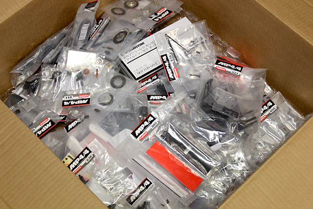 Image of a box of packaged parts from the full Senna McLaren MP4/4 model kit from DeAgostini ModelSpace