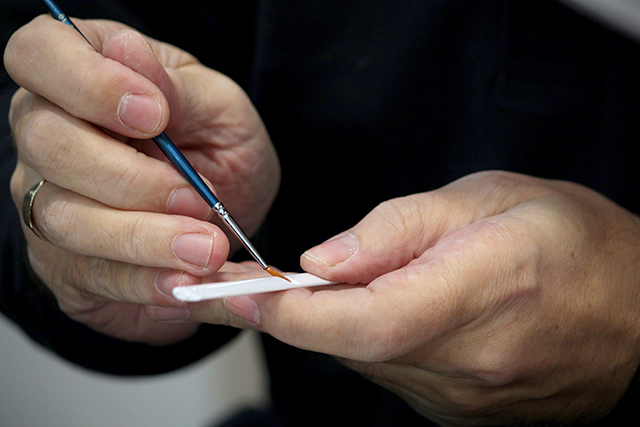 man applying to glue to scale model Senna McLaren MP4/4 scale model car, as part of a blog about choosing your first scale model.