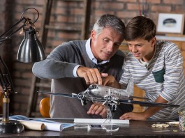 Image of father and son building scale model of DC3
