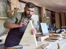 Image of man sanding wood, as the cover image for a blog about abrasives and how to sand scale models.